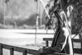 Beautiful young woman pensive in a park with a blank stare. Black and white photo