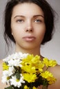 Beautiful young woman with perfect clean shiny skin, natural fashion makeup with spring flowers. Close-up woman, fresh spa look Royalty Free Stock Photo