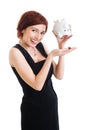 Beautiful young woman with piggy bank