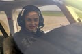 Beautiful Young Woman Pilot With Headset Looking Through The Cockpit Window Royalty Free Stock Photo