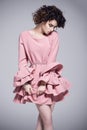 Beautiful young woman in a pink dress with frills