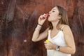 Beautiful young woman playing with a bubble blower Royalty Free Stock Photo