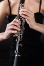 Beautiful young woman playing clarinet