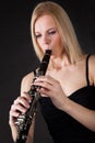 Beautiful young woman playing clarinet