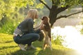 Beautiful young woman playing with her Dog in the Park in the autumn Royalty Free Stock Photo