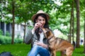 Beautiful young woman playing with her dogin a park outdoors. Lifestyle portrait. Cute young woman hugs her puppy dog. Love Royalty Free Stock Photo
