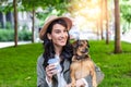 Beautiful young woman playing with her dogin a park outdoors. Lifestyle portrait. Cute young woman hugs her puppy dog. Love Royalty Free Stock Photo