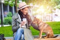 Beautiful young woman playing with her dogin a park outdoors. Lifestyle portrait. Cute young woman hugs her puppy dog. Love Royalty Free Stock Photo