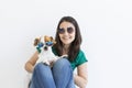 Beautiful young woman playing with her little cute dog at home. Lifestyle portrait. Love for animals concept. white background.