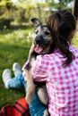 young woman playing with her young dog in the park outdoors. Life style portrait. Royalty Free Stock Photo