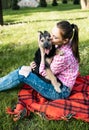 young woman playing with her young dog in the park outdoors. Life style portrait. Royalty Free Stock Photo