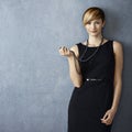 Beautiful young woman playing with pearl necklace Royalty Free Stock Photo