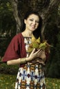 Beautiful young woman plays with leafs Royalty Free Stock Photo