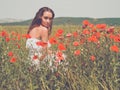 Beautiful young woman in the poppy field Royalty Free Stock Photo