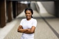 Beautiful young woman portrait in a city. Smiling african american girl with crossed arms looking at camera. People, business, Royalty Free Stock Photo