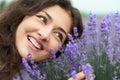 Beautiful young woman portrait on lavender flowers background, face closeup Royalty Free Stock Photo