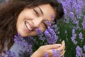 Beautiful young woman portrait on lavender flowers background, face closeup Royalty Free Stock Photo