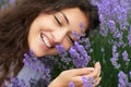 Beautiful young woman portrait on lavender flowers background, face closeup Royalty Free Stock Photo