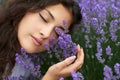 Beautiful young woman portrait on lavender flowers background, face closeup Royalty Free Stock Photo