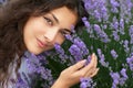 Beautiful young woman portrait on lavender flowers background, face closeup Royalty Free Stock Photo