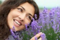 Beautiful young woman portrait on lavender flowers background, face closeup Royalty Free Stock Photo