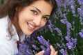 Beautiful young woman portrait on lavender flowers background, face closeup Royalty Free Stock Photo