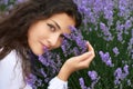 Beautiful young woman portrait on lavender flowers background, face closeup Royalty Free Stock Photo