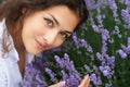 Beautiful young woman portrait on lavender flowers background, face closeup Royalty Free Stock Photo