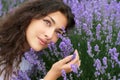 Beautiful young woman portrait on lavender flowers background, face closeup Royalty Free Stock Photo