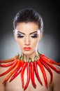 Beautiful young woman portrait with red hot and spicy peppers Royalty Free Stock Photo