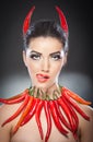 Beautiful young woman portrait with red hot and spicy peppers Royalty Free Stock Photo