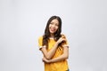 Beautiful young woman portrait. Smiling asian lifestyle concept with crossed arms. Isolated on grey background Royalty Free Stock Photo