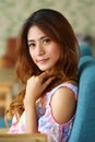 Beautiful young woman posing alone in the cafe