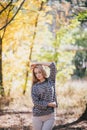 Beautiful young woman posing in an autumn forest