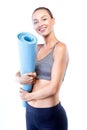 Beautiful young woman posing after doing pilates over white background. Royalty Free Stock Photo