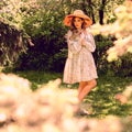 Beautiful young woman posing in the Park. Summer dress and hat
