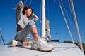 Beautiful young woman posing on yacht. Model is sailing on board Royalty Free Stock Photo