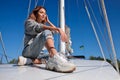 Beautiful young woman posing on yacht. Model is sailing on board Royalty Free Stock Photo