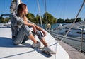 Beautiful young woman posing on yacht. Model is sailing on board Royalty Free Stock Photo