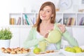 Beautiful young woman pouring tea in cup Royalty Free Stock Photo