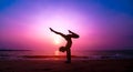 Beautiful young woman practic yoga at the beach. Early morning exercise. Sunrise Royalty Free Stock Photo