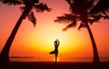 Beautiful young woman practic yoga at the beach. Early morning exercise. Sunrise Royalty Free Stock Photo