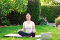 Beautiful young woman practicing yoga in garden outdoors Royalty Free Stock Photo