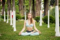 Beautiful young woman practicing yoga in park and making namaste mudra Royalty Free Stock Photo