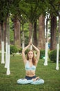 Beautiful young woman practicing yoga in park and making namaste mudra Royalty Free Stock Photo
