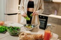 Beautiful young woman preparing vegetable vegan salad in the kitchen. Healthy food and diet concept lifestyle. Cook at home Royalty Free Stock Photo