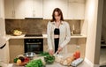 Beautiful young woman preparing vegetable vegan salad in the kitchen. Healthy food and diet concept lifestyle. Cook at home Royalty Free Stock Photo