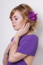 Beautiful young woman in purple dress with flowers Royalty Free Stock Photo