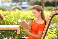 Beautiful young woman reading book outdoors Royalty Free Stock Photo