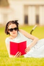 Beautiful young woman reading book in the park Royalty Free Stock Photo